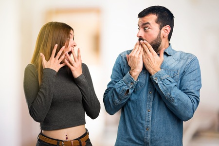 Man and woman making surprise gesture on unfocused backgroundの写真素材