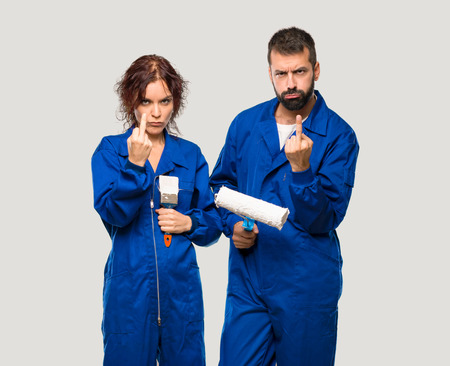 Painters making horn gesture. Negative expression on isolated grey backgroundの写真素材