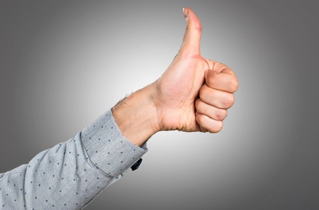 Hand of man with thumb up