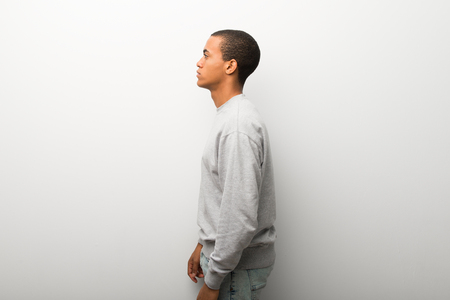 African american man on white wall background in lateral positionの写真素材
