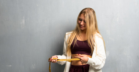 Young sport woman with tape measureの写真素材