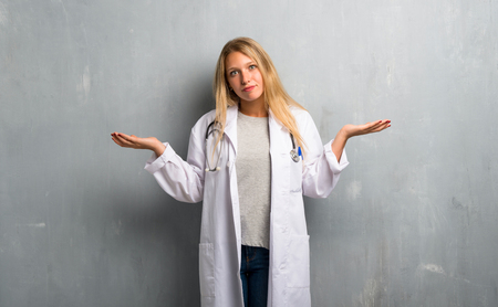 Young doctor woman having doubts and with confuse face expressionの写真素材