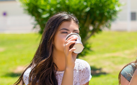Happy holding coffee in takeaway paper cup