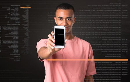 Young african american man looking at the camera and smiling while using the mobile