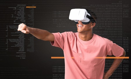 Young african american man using VR glasses. Virtual reality experienceの写真素材