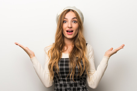 Fashionably woman wearing hat with surprise and shocked facial expressionの写真素材
