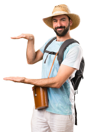 Funny tourist holding something on isolated white backgroundの写真素材