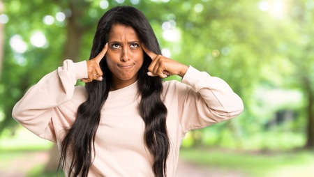 Young afro american woman having doubts and thinking at outdoorsの写真素材