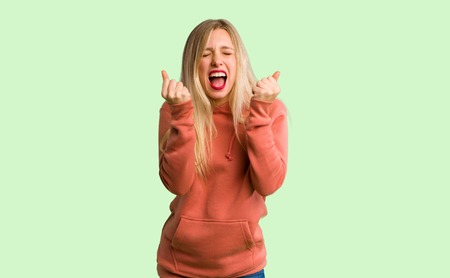 Young girl frustrated by a bad situation on green background
