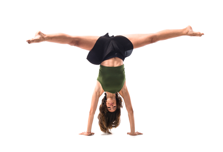 Young girl dancing in studio on isolated backgroundの写真素材