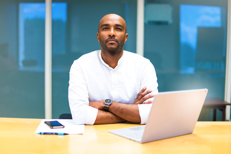 Young afro american businessman in the office with his laptop