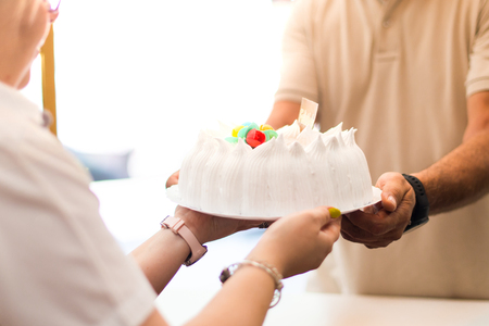 Man buying a cake in a bakeryの写真素材