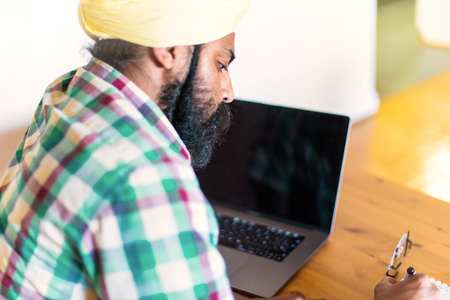 Indian with turban working with his laptopの写真素材