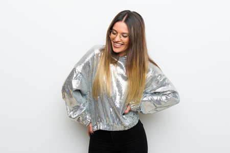 Young woman with glasses over white wall happy and smilingの写真素材