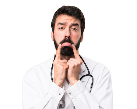 Sad young doctor on white backgroundの写真素材