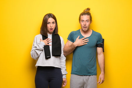 Group of athletes over yellow background surprised and shocked while looking rightの写真素材