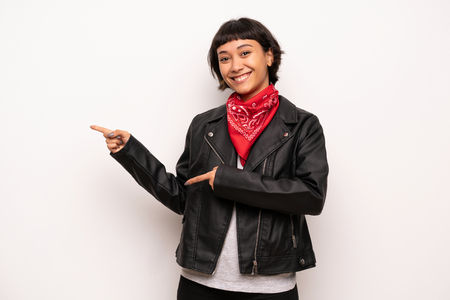 Woman with leather jacket and handkerchief pointing finger to the side in lateral positionの写真素材