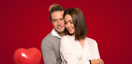 Happy couple in valentine day over red background
