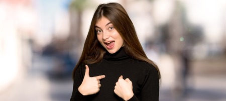 Pretty girl with surprise facial expression at outdoorsの写真素材