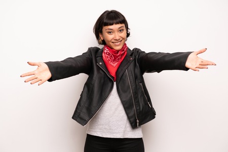 Woman with leather jacket and handkerchief presenting and inviting to come with handの写真素材