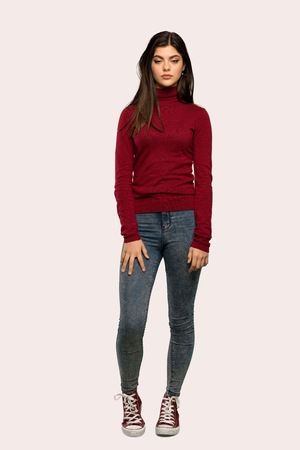 A full-length shot of a Teenager girl with turtleneck portrait over isolated background