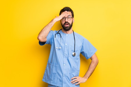 Surgeon doctor man with surprise and shocked facial expressionの写真素材