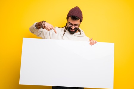 Hippie man with dreadlocks holding a placard for insert a conceptの写真素材