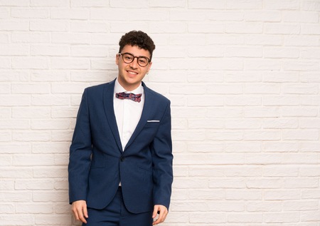 Man in suit and bow tie with glasses and happyの写真素材