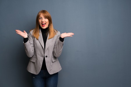 Redhead business woman with surprise and shocked facial expressionの写真素材