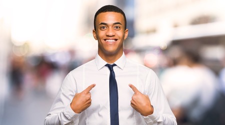 Young afro american businessman with surprise facial expression in the cityの写真素材