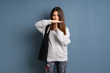 Young sport woman making time out gesture