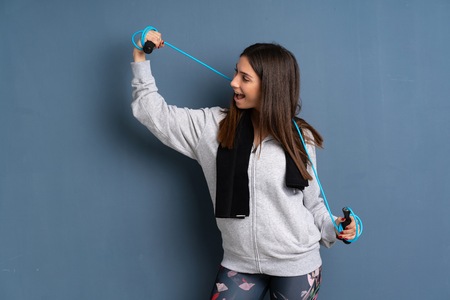 Young sport woman with jumping rope