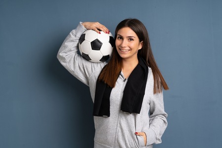 Young sport woman holding a soccer ballの写真素材