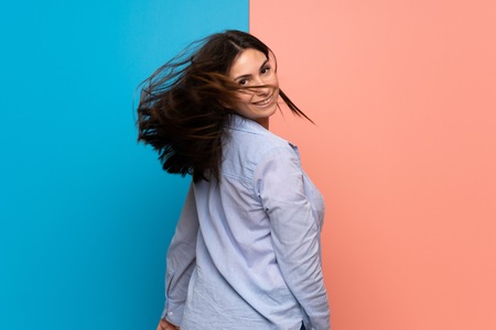 Young woman over pink and blue wallの写真素材