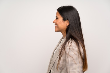 Young Colombian girl over white wall laughingの写真素材