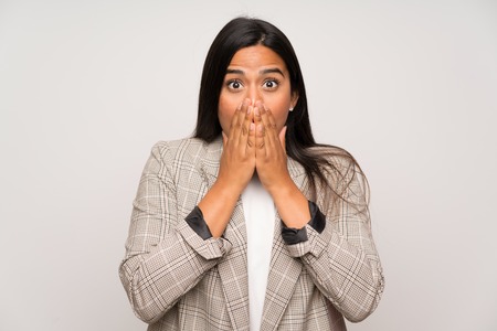 Young Colombian girl over white wall with surprise facial expressionの写真素材