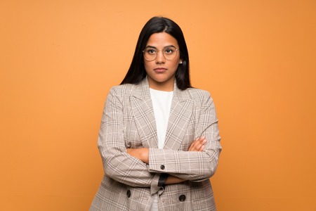 Young Colombian girl over brown wall portraitの写真素材