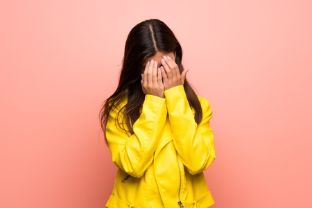 Teenager girl over pink wall with tired and sick expressionの写真素材
