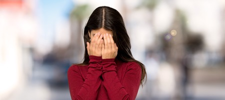 Teenager girl with turtleneck with tired and sick expression at outdoorsの写真素材