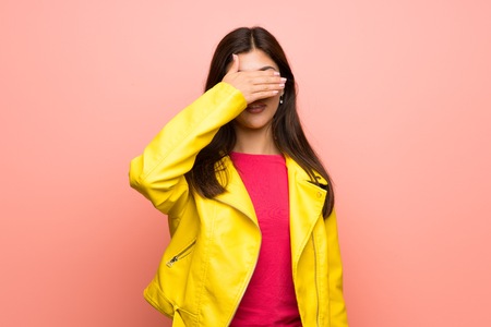 Teenager girl over pink wall covering eyes by hands. Do not want to see somethingの写真素材