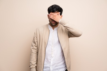 Young man over isolated wall covering eyes by hands. Do not want to see somethingの写真素材