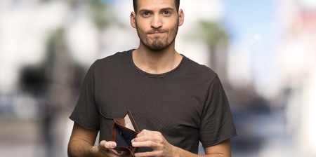 Man with black shirt holding a wallet at outdoors
