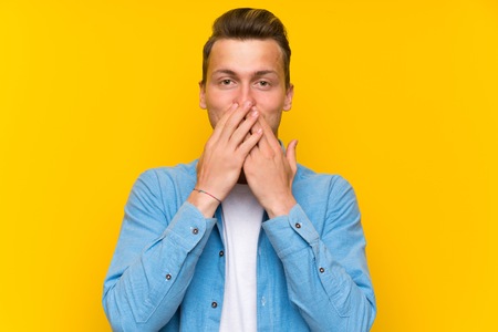 Blonde handsome man over isolated wall with surprise facial expressionの写真素材