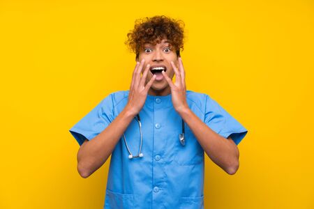 Surgeon doctor african american man with surprise facial expressionの写真素材