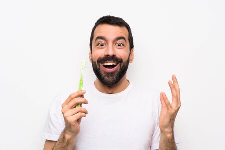 Man with beard brushing teeth over isolated white background