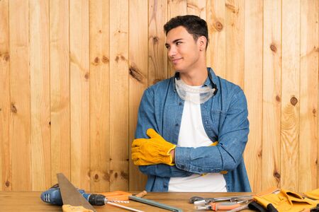 Craftsmen man over wood background thinking an ideaの写真素材