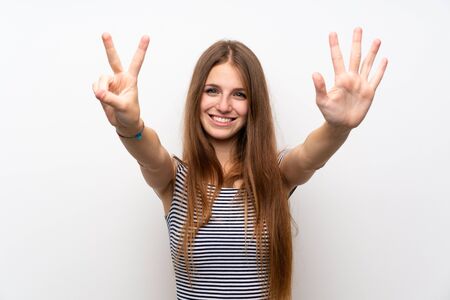 Young woman with long hair over isolated white wall counting seven with fingersの写真素材