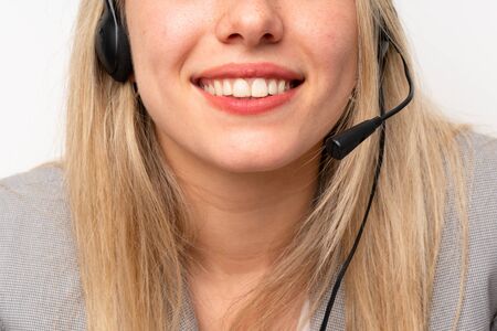 Young woman working with headset in a officeの写真素材