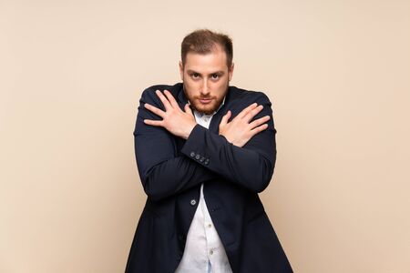 Blonde man over isolated background freezingの写真素材
