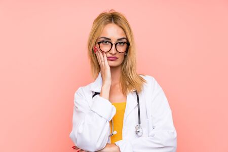 Young blonde doctor woman unhappy and frustratedの写真素材